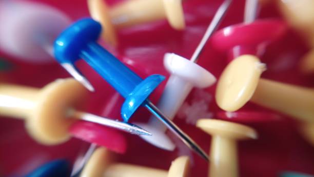 istock Macro photo of multi-colored clerical buttons, pushpin 911727740