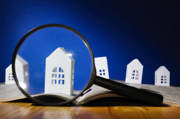 istock Paper house under a magnifying lens 911728506