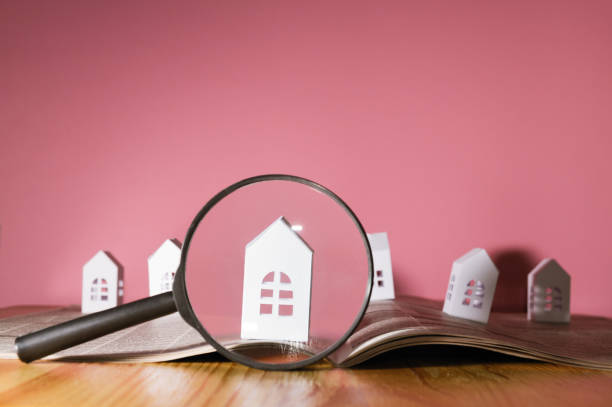 istock Paper house under a magnifying lens 911728544