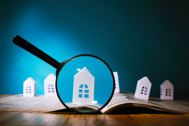Paper house under a magnifying lens