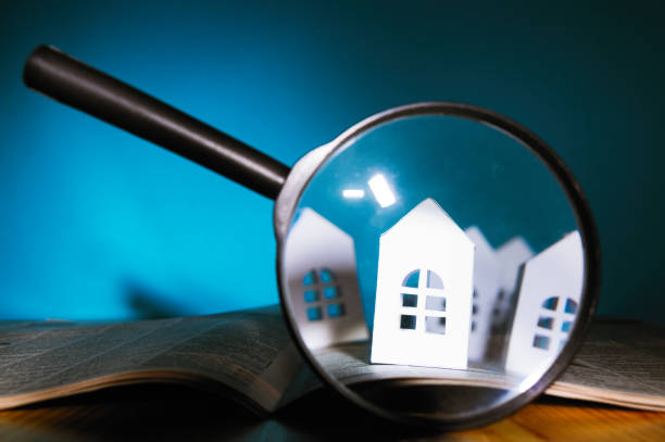istock Paper house under a magnifying lens 911728604