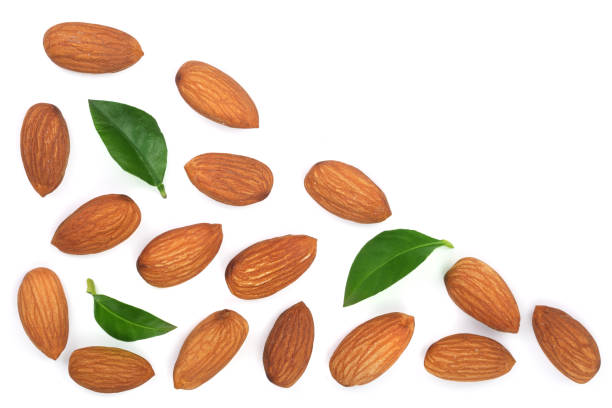 istock almonds with leaves isolated on white background with copy space for your text. Top view. Flat lay pattern 911730874