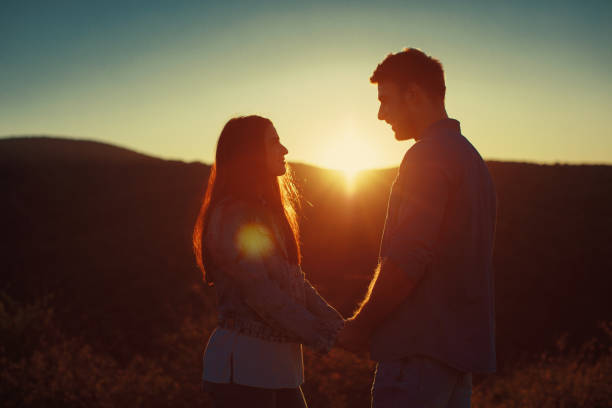 istock Young loving couple enjoys the sunset 911731030