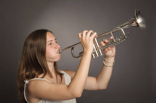 istock woman playing trumpet 911731336