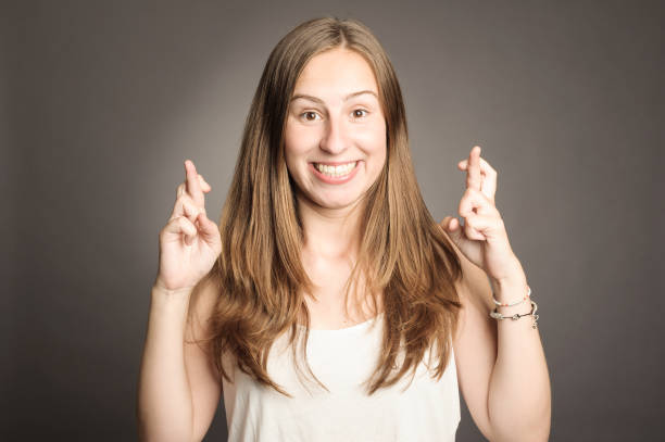 istock young girl crossing fingers 911731386