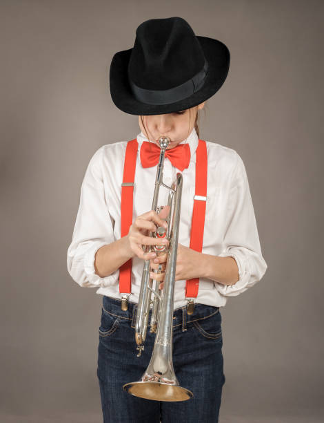 istock little girl playing trumpet 911731490