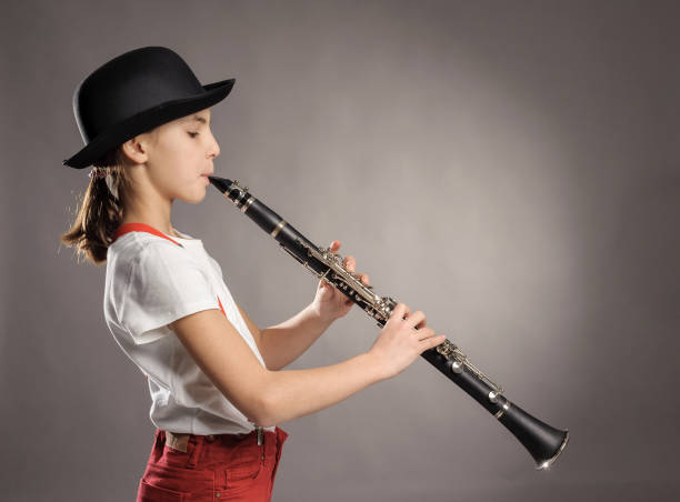 istock little girl playing clarinet 911731626