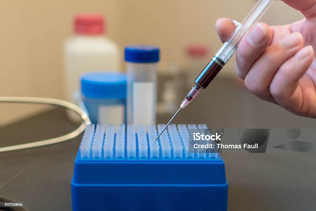 Hand Using A Syringe Hand Using A Syringe With Blood In A Science Laboratory Stock Photo ...