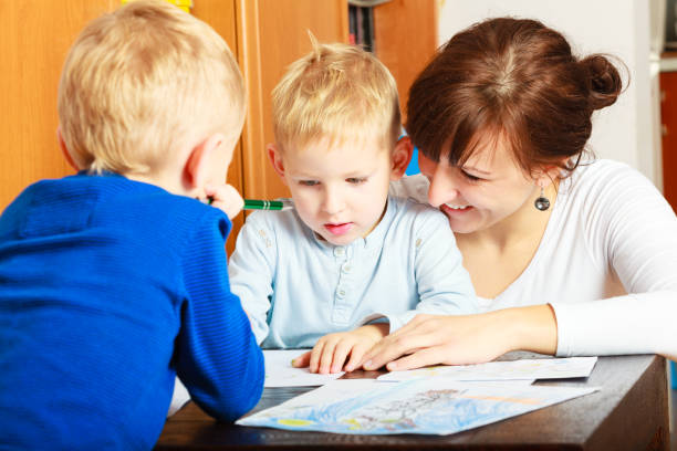 istock mother and children sons drawing together 911735020
