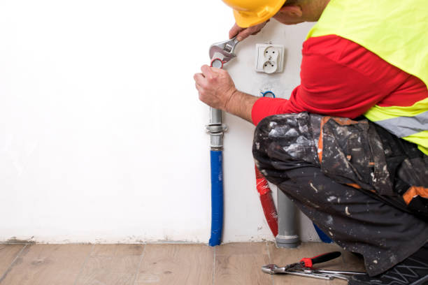 istock Hands of Plumber with a wrench 911735044
