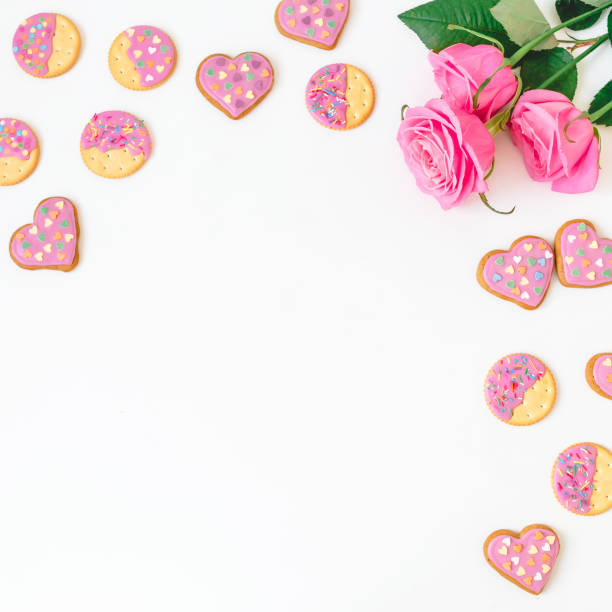 istock Gingerbread cookies and roses on white background. Frame, copy space. Flat lay. top view. 911735656