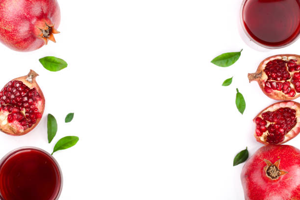 istock pomegranate juice with fresh pomegranate fruits isolated on white background with copy space for your text. Top view 911736002