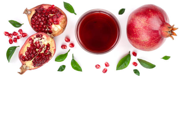 istock pomegranate juice with fresh pomegranate fruits isolated on white background with copy space for your text. Top view 911736430