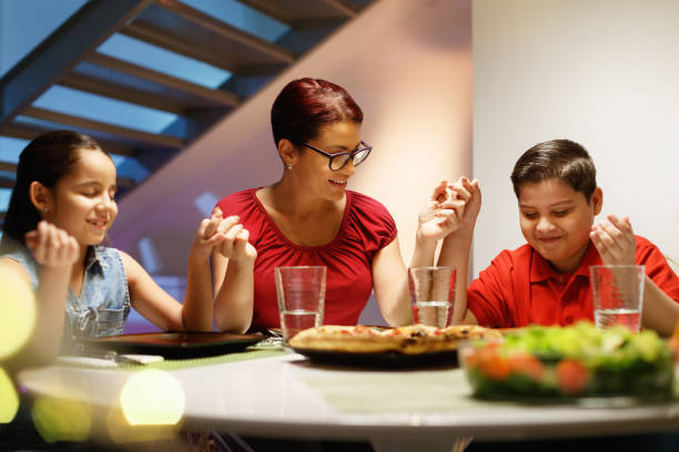 istock Dinner At Home With Happy Family Praying Before Eating 911738958