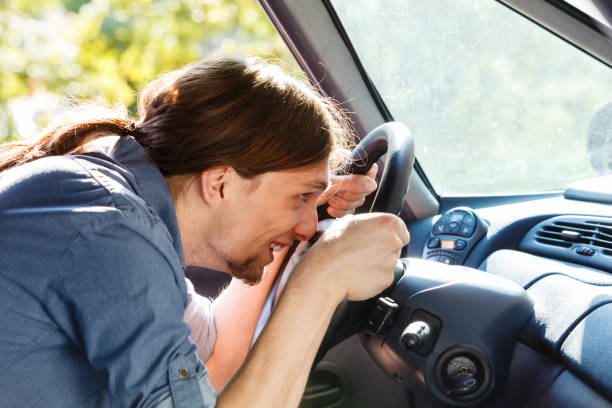 istock Man in car fooling around 911739414