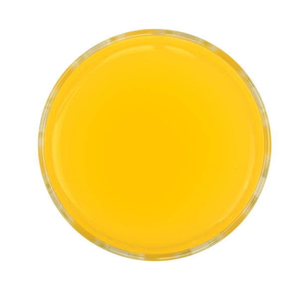 istock orange or pineapple juice in a glass isolated on white background. Top view 911742082