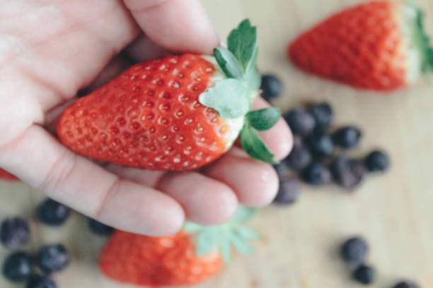 istock Strawberries and blueberries on wooden background 911742648
