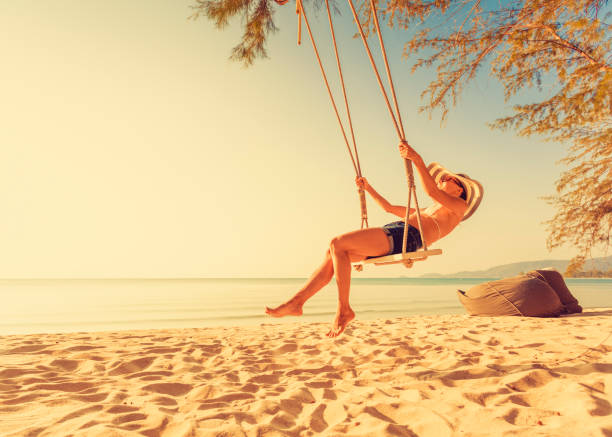 istock Woman at tropical swing 911743272