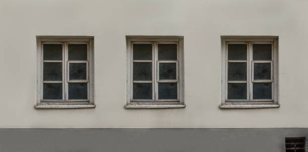 istock Old European classic building three windows facade 911746324
