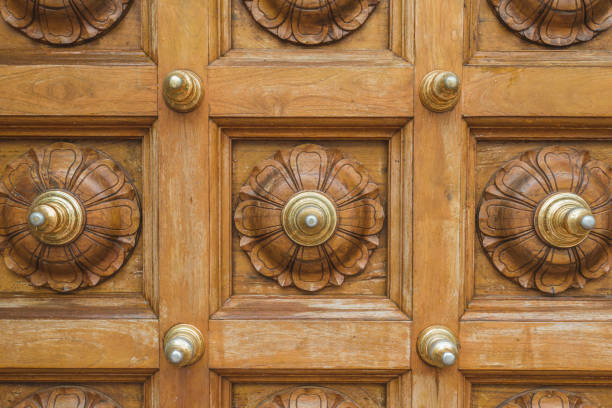 wooden floral ornament on massive door of Hindu temple in Singapore
