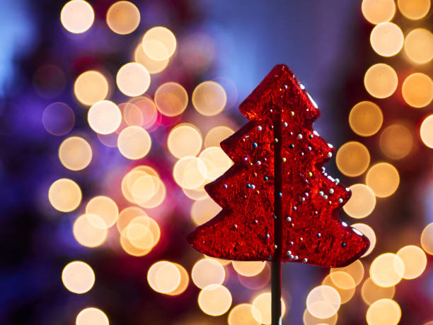 Colorful defocused party lights background.  Hues include: pink, purple, blue, green.