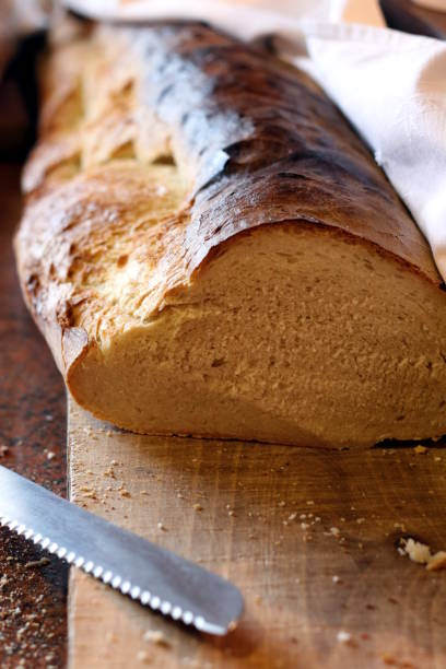 istock Bread loaf on wooden cutting board 911750684