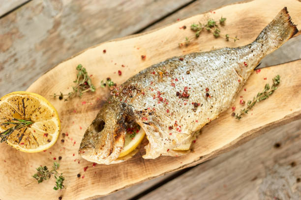 istock Roasted fish with garnish, closeup. 911755236