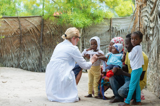 Medical exam of African family Caucasian female doctor listening heart beat and breathing of little African girl , family looking medical exam ebola stock pictures, royalty-free photos & images