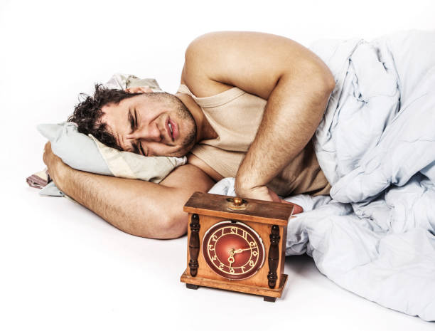 istock Young man wakes to a loud alarm clock 911761868