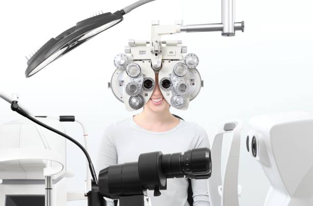 istock optometrist exam, eyesight  woman patient with phoropter in optician office 911762092