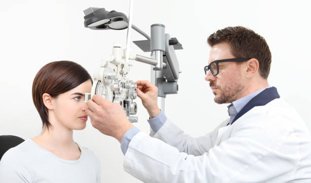 istock optometrist doing eyesight with woman patient measurement with optical phoropter isolated on white 911762120
