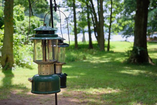 Close up of gas lanterns hanging on pole in woods