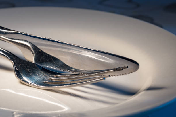 istock Stainless steel cutlery on white plate 911777344