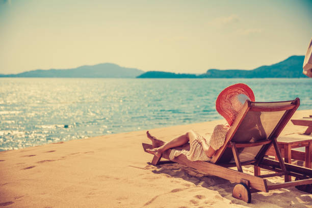 istock Woman in beach chair 911788204