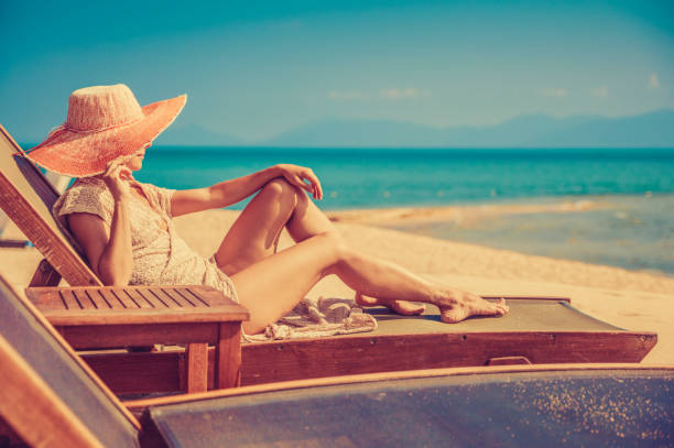 istock Woman in beach chair 911790632