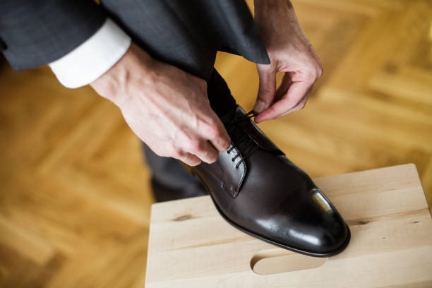 istock Young Man tying elegant shoes 911791512