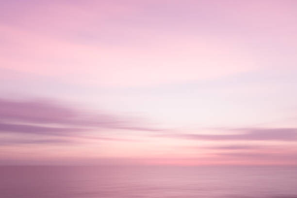 istock Abstract pink sunset sky and ocean nature background with blurred panning motion. 911793952