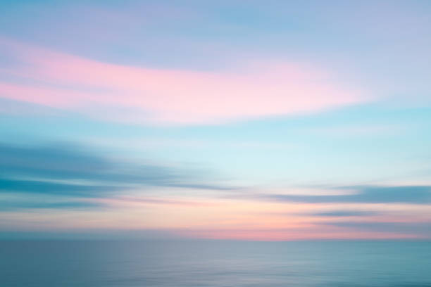 istock Abstract colorful sunset sky and ocean nature background with blurred panning motion. 911793958