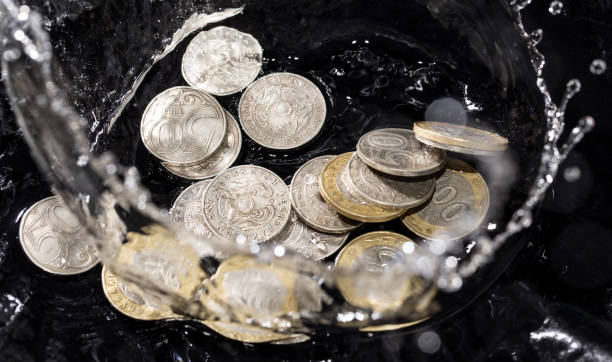 istock coins in water splashes on a black background 911794184