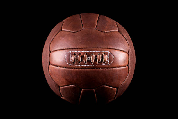 istock Old football leather ball on a black background 911795248
