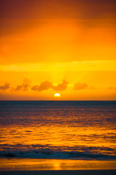Summer background evening beach at sunset with waves