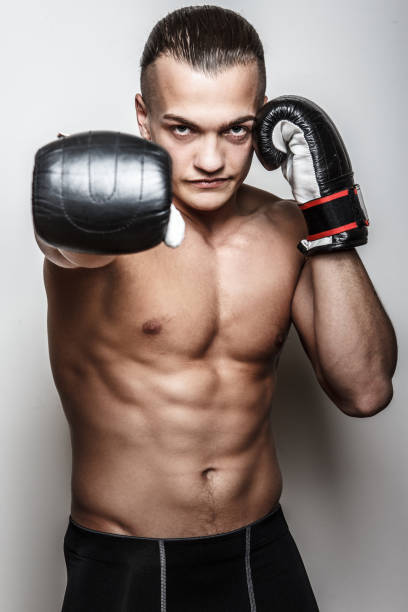 istock Muscular guy in boxing gloves 911796644