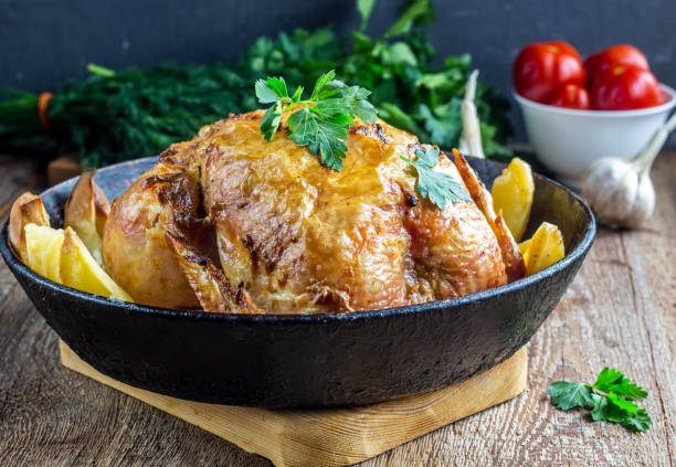 istock Whole roasted chicken with potato on a pan 911801324