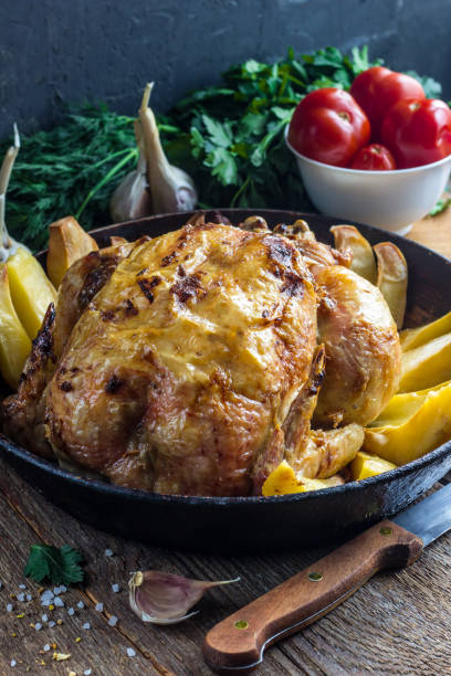 istock Whole roasted chicken with potato on a pan 911801334