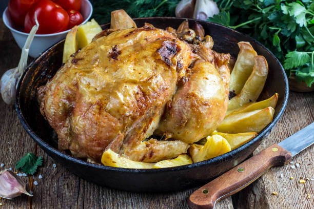 istock Whole roasted chicken with potato on a pan 911801378