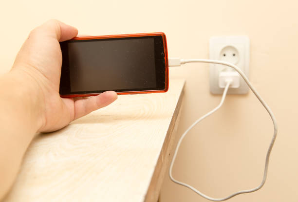 istock cell phone charging in your hand 911801516