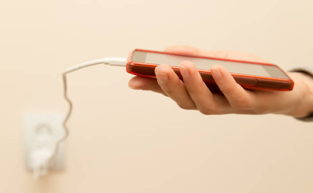 istock cell phone charging in your hand 911801610
