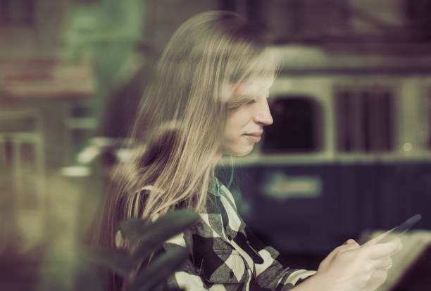 Beautiful girl reads a book in a cafe
