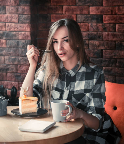 Beautiful girl drinks tea in a cafe