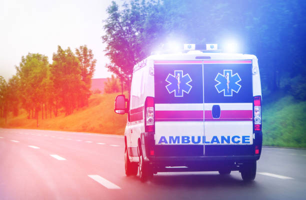 Ambulance van on highway with flashing lights Ambulance van on highway with flashing lights ambulance photos stock pictures, royalty-free photos & images